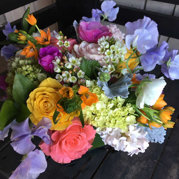 Colorful bouquet of roses, sweet peas, and mixed blooms