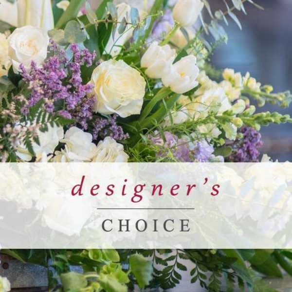 White and lavender floral arrangement with mixed blooms and greenery
