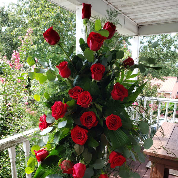 Tall bouquet of red roses with eucalyptus greenery