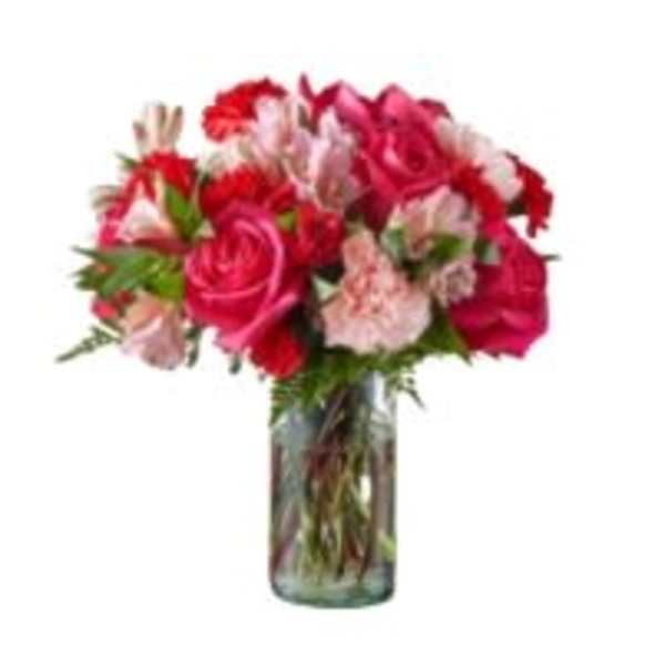 Bouquet of pink and red flowers in a clear glass vase