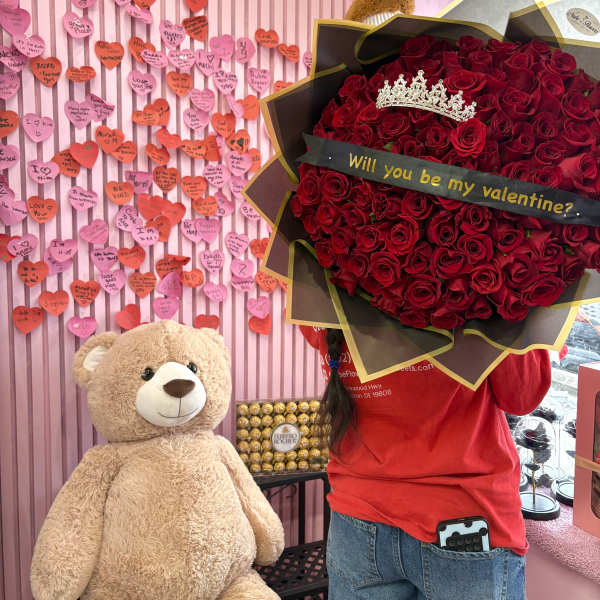 Large bouquet of red roses with a tiara and Valentine message ribbon