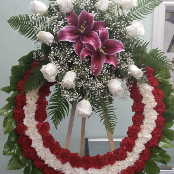 Standing floral wreath with white roses and magenta lilies