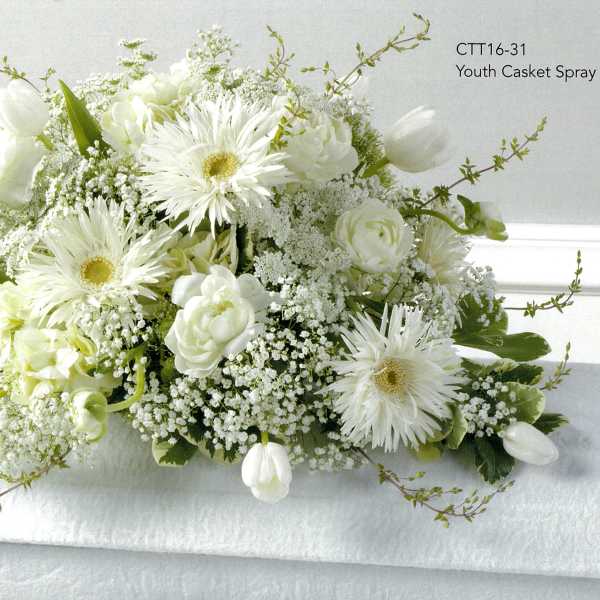 White floral casket spray with daisies and tulips