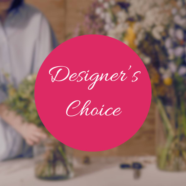 Pink circle with "Designer’s Choice" over a blurred florist workspace