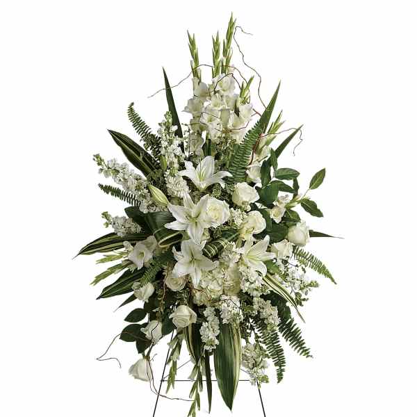 Tall white floral standing spray with lilies and roses on a wire easel