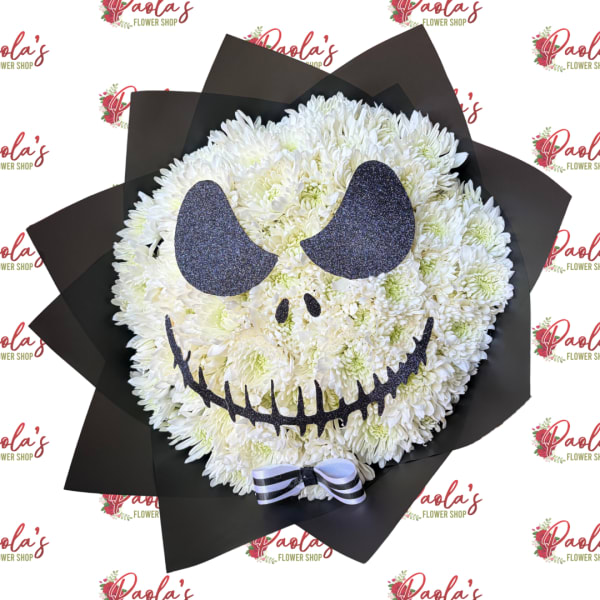 White chrysanthemum arrangement shaped like a skull with black paper wrap and bow