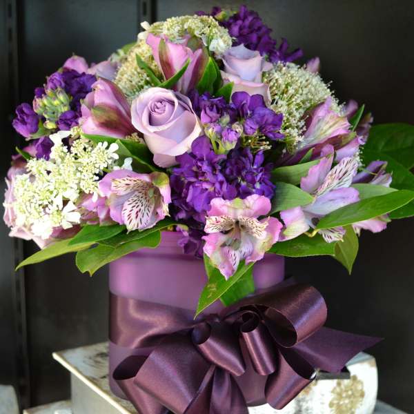 Purple and pink bouquet in a lavender box with a satin ribbon
