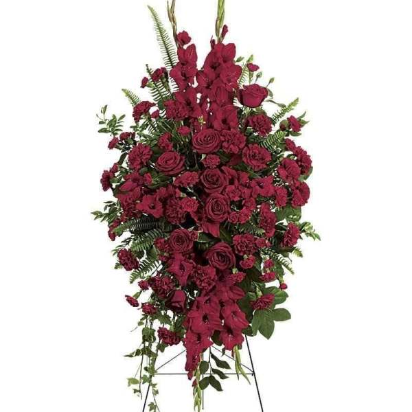 Tall red floral standing spray on an easel