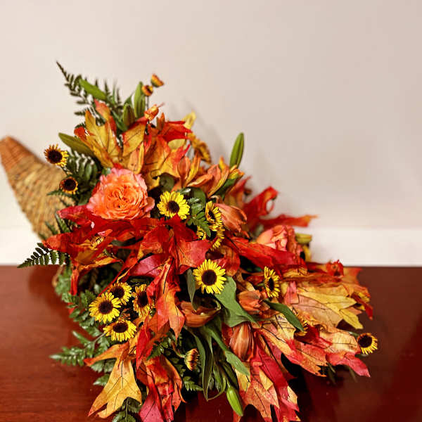 Autumn bouquet with orange roses and yellow daisy-like flowers