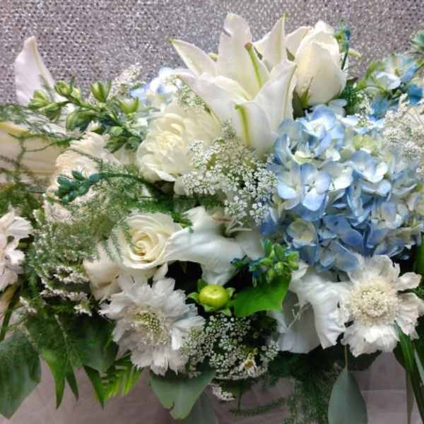 White and blue floral arrangement with lilies and hydrangeas