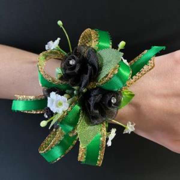 Green ribbon wrist corsage with small black and white flowers