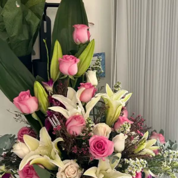Pink roses and white lilies arranged in a large bouquet