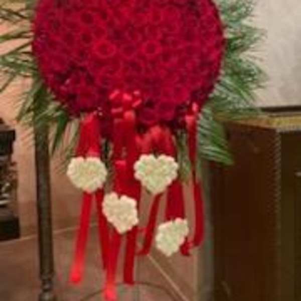 Heart-shaped red floral standing spray with white heart accents