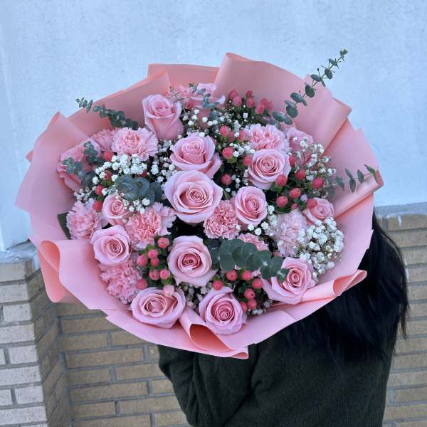 Pink rose bouquet with carnations and baby's breath in pink wrap