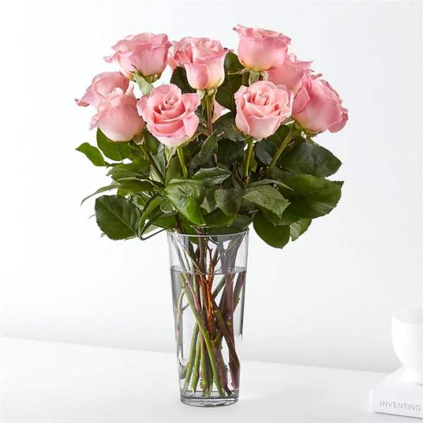 Pink roses arranged in a clear glass vase