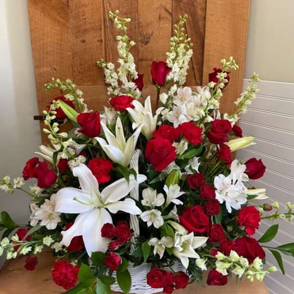 Large basket arrangement of red roses and white lilies