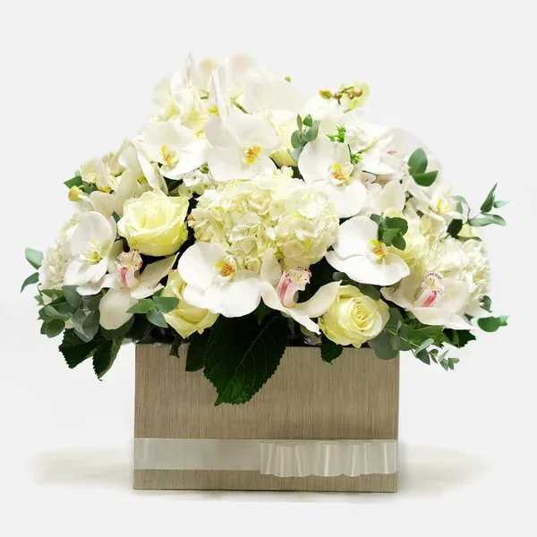 White orchids and pale roses in a square box with ribbon