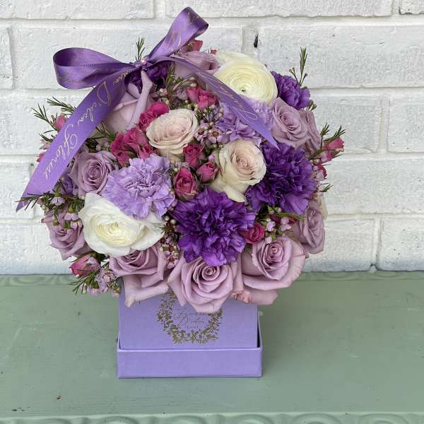 Lavender and purple rose bouquet in a purple box with ribbon
