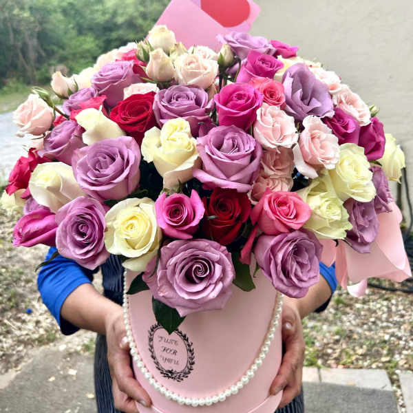 Pink hatbox arrangement of roses with a heart card