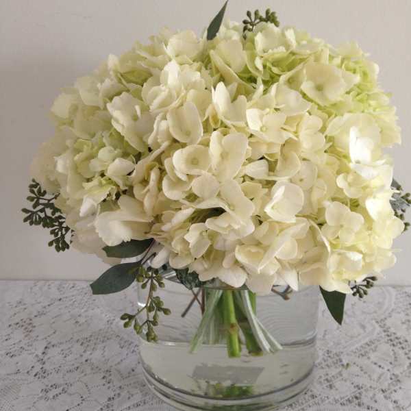 White hydrangea bouquet in a clear glass vase