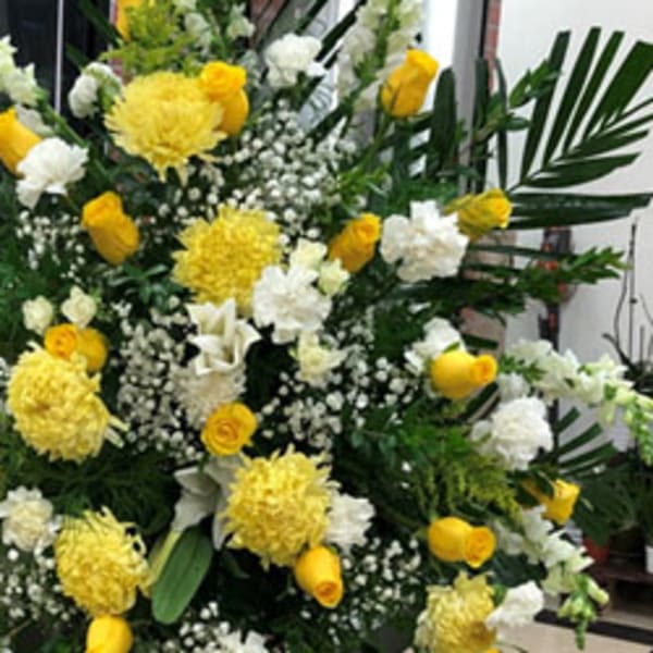 Large yellow and white floral spray with palm fronds