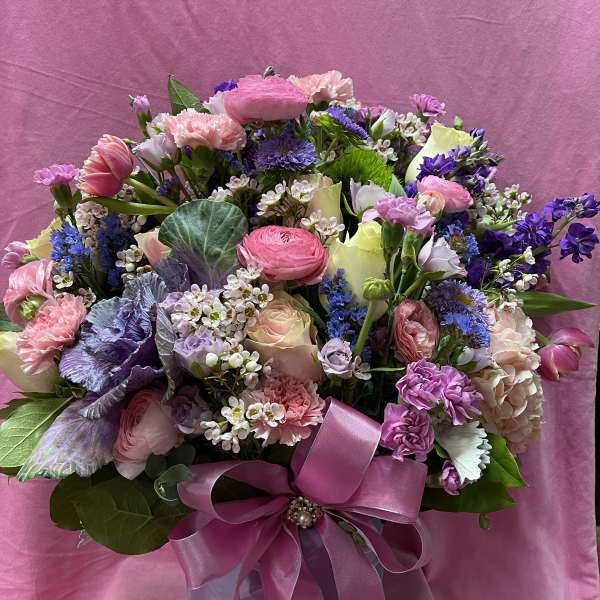 Mixed pink and purple bouquet in a gift box with a satin ribbon