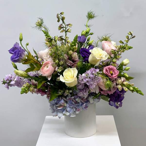 Mixed pastel bouquet in a white cylindrical vase
