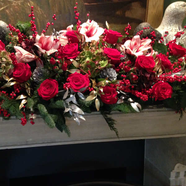 Long floral arrangement with red roses and pink lilies