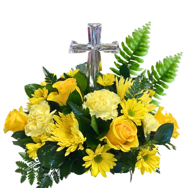 Yellow roses and daisies arranged around a silver cross