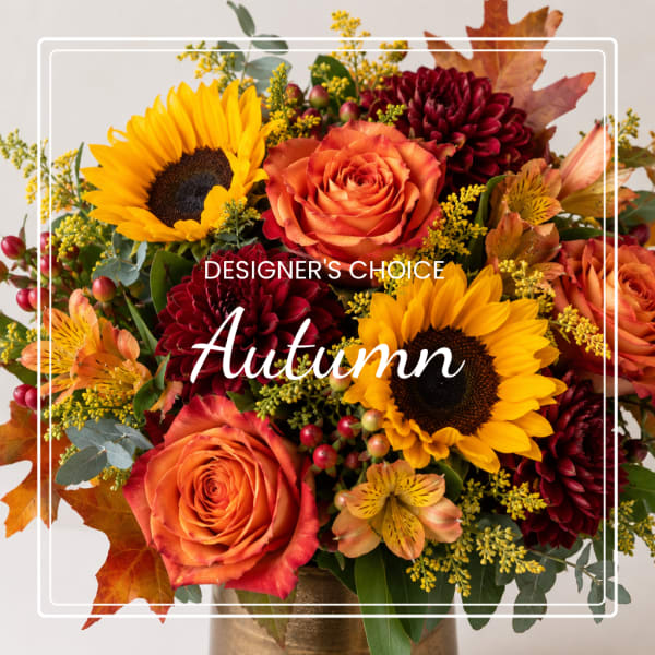 Autumn bouquet with sunflowers, orange roses, and burgundy blooms in a vase
