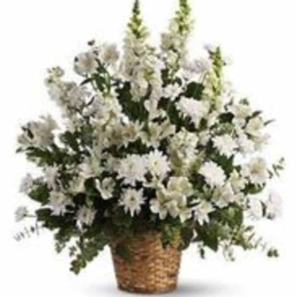 White floral arrangement in a woven basket