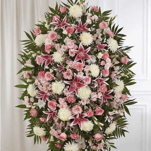 Standing spray of pink and white flowers with lilies and roses