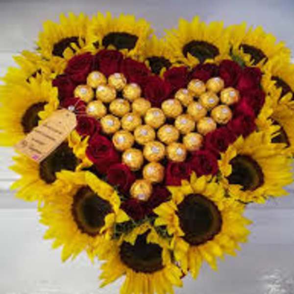 Heart-shaped bouquet of red roses and sunflowers with gold chocolates in the center