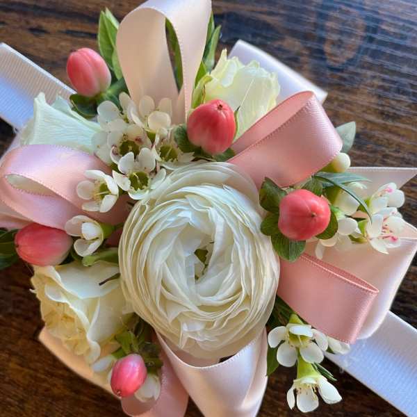 Small bouquet of white flowers with pink ribbon and pink berry accents