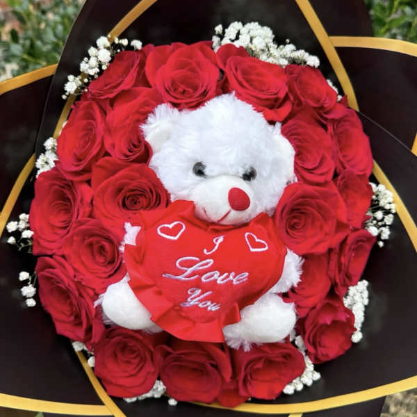 Red rose bouquet with a white teddy bear holding a heart