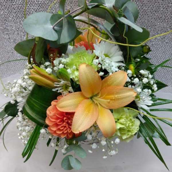 Mixed bouquet with orange lilies, white daisies, and greenery
