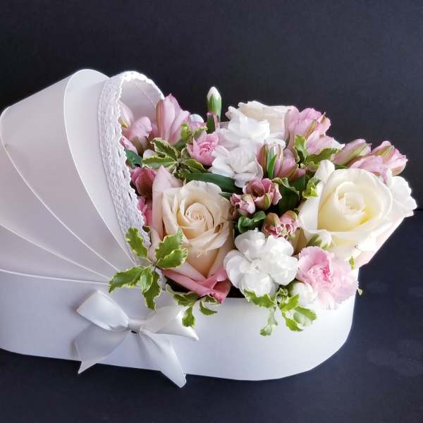 Pink and white bouquet in a white heart-shaped box