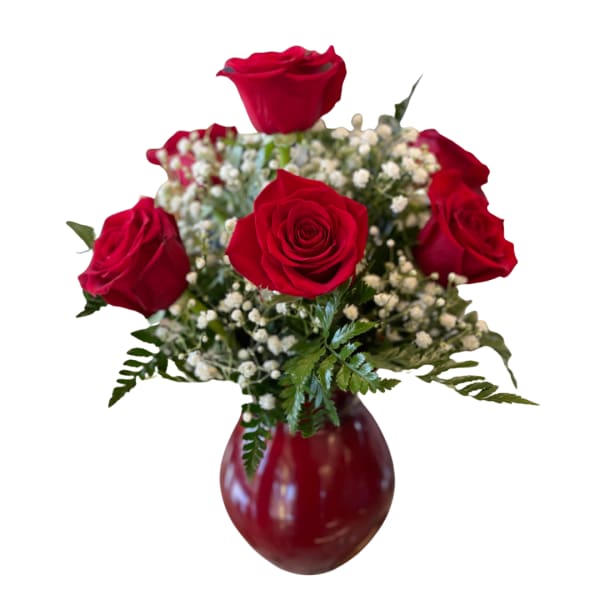 Red roses arranged in a red vase with baby's breath