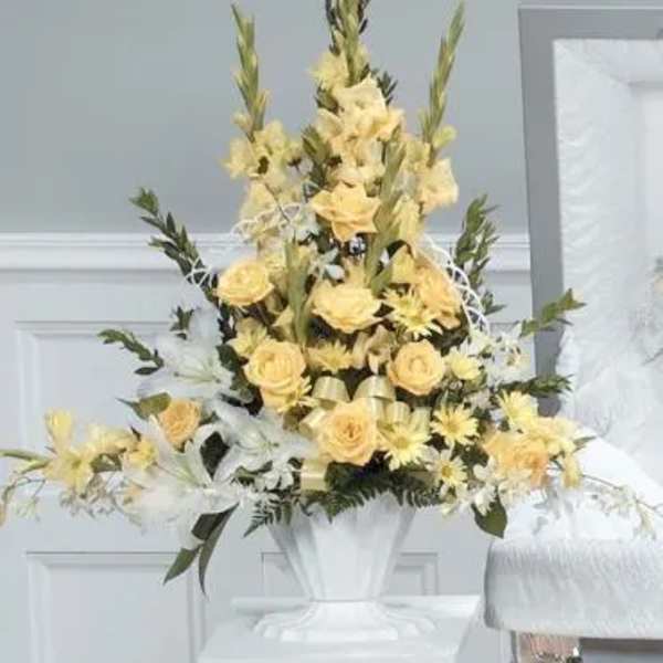 Tall yellow floral arrangement in a white vase