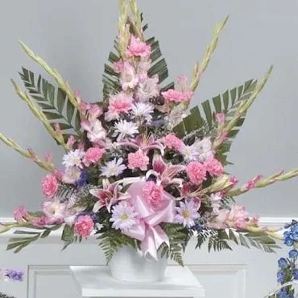 Tall pink and white floral arrangement in a white vase