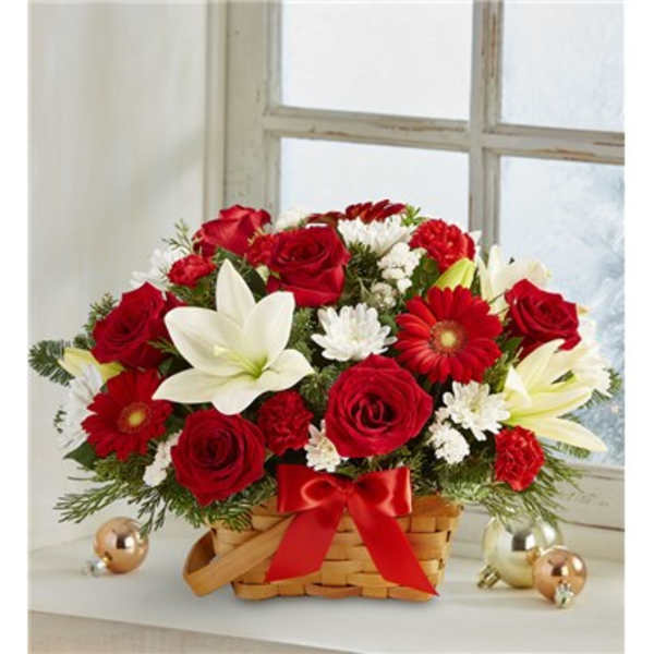 Basket arrangement of red roses, white lilies, and red daisies with a ribbon