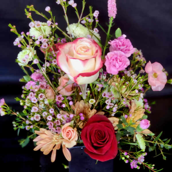 Mixed bouquet with red and pink roses and small filler flowers