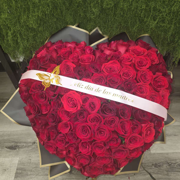Heart-shaped bouquet of red roses with a ribbon