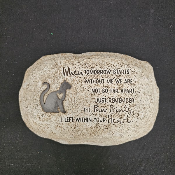 Decorative stone plaque with a cat silhouette and memorial text