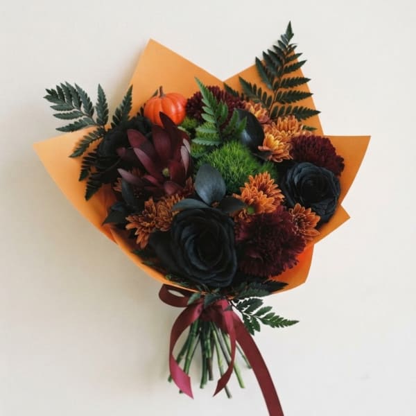 Bouquet of dark flowers with orange wrapping and a burgundy ribbon