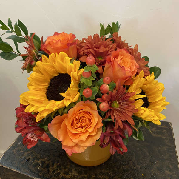 Orange and yellow mixed bouquet in a yellow vase