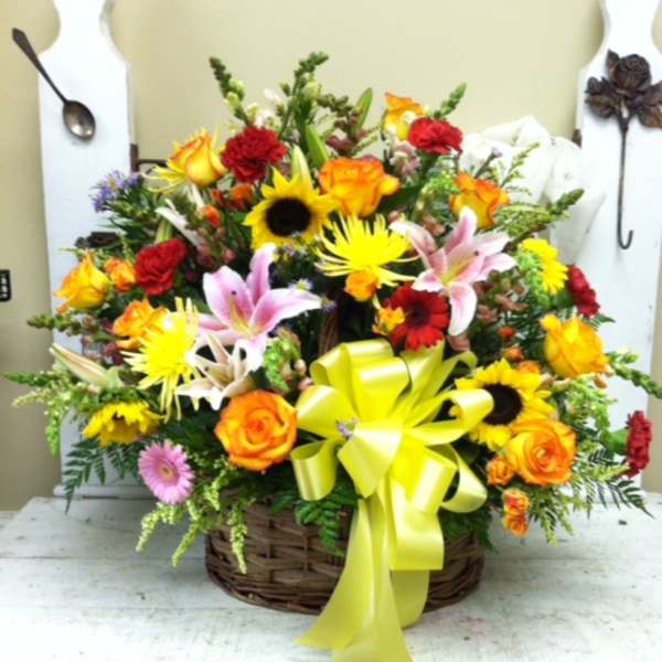 Mixed flower basket with a yellow ribbon bow