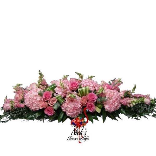 Long pink floral arrangement with roses and hydrangeas