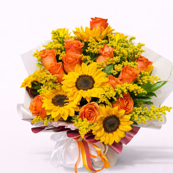 Bouquet of sunflowers and orange roses wrapped in white paper