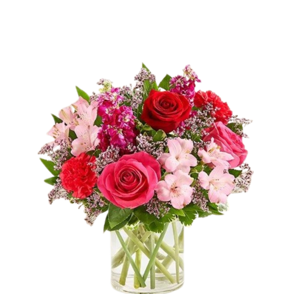 Pink and red mixed bouquet in a clear glass vase